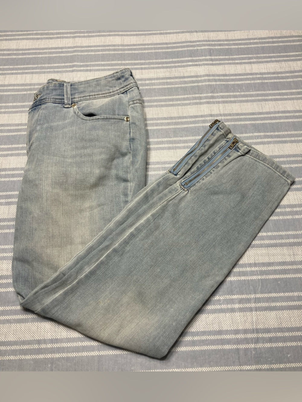 Chico's Platinum Denim light blue jeans with ankle zippers.